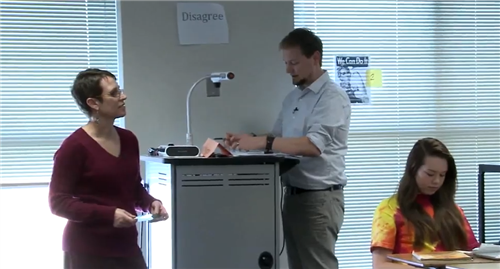 Teachers co-teaching at projector 